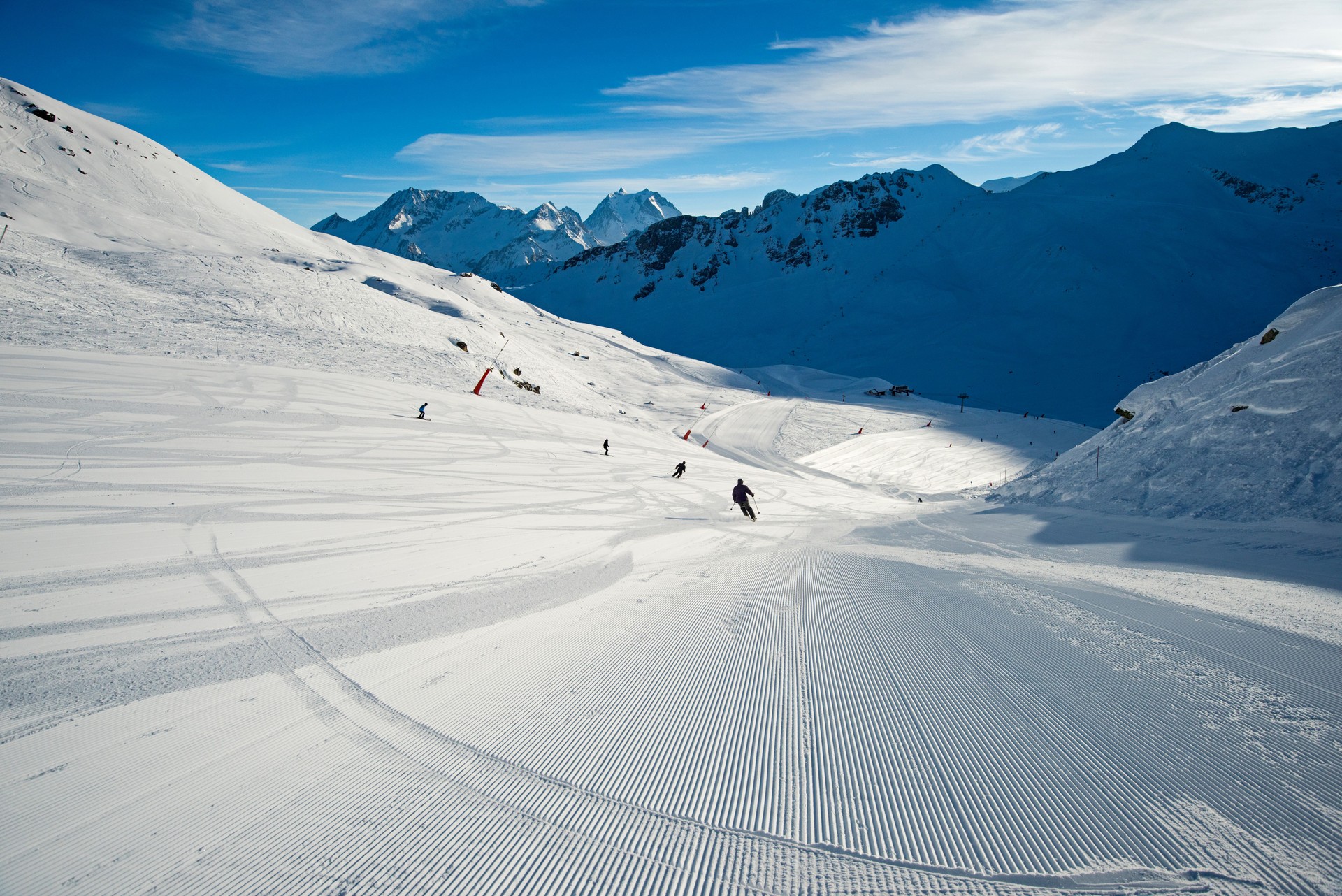 Skiers on a piste in alpine ski resort