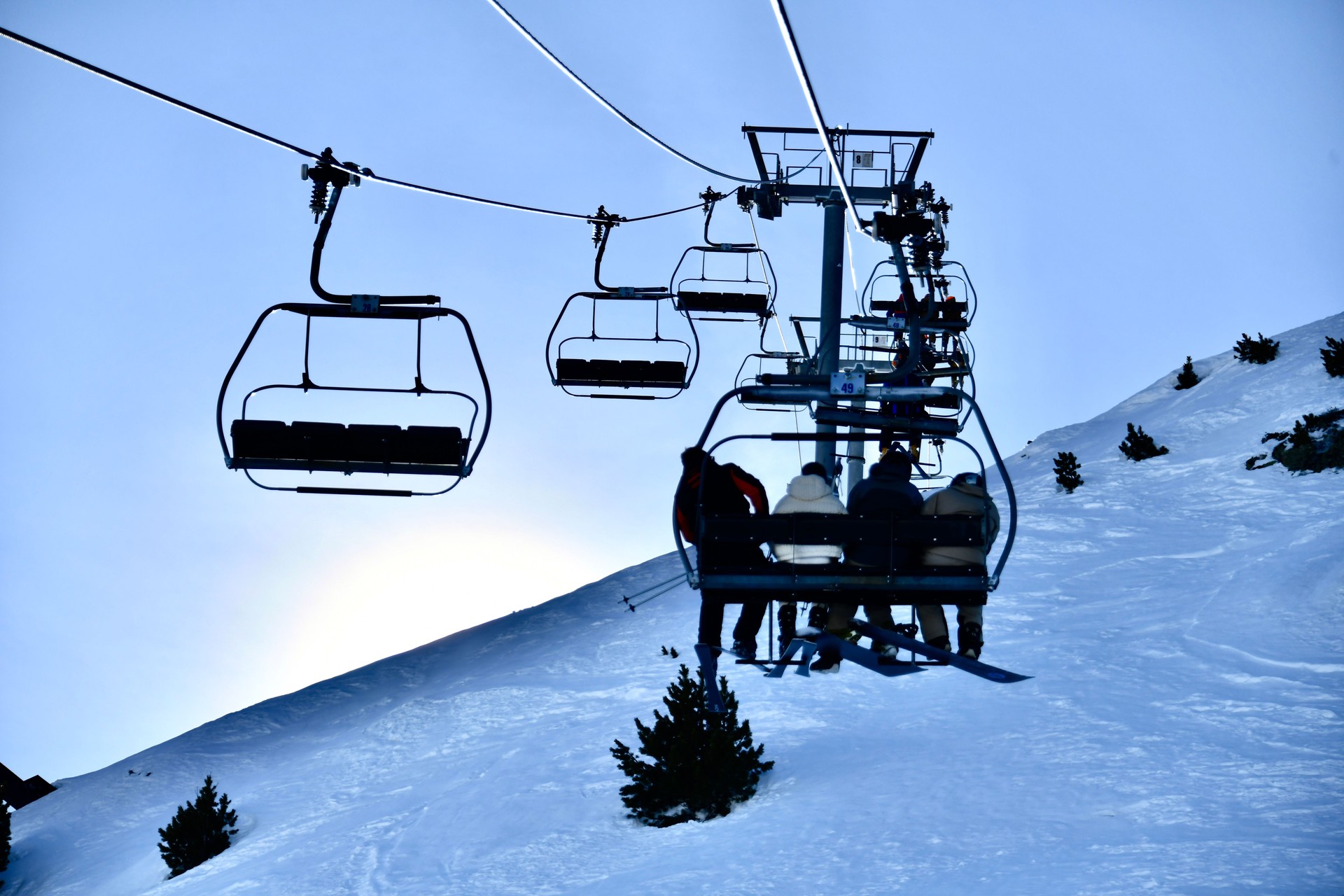 People going up in chairlift on snowy mountain